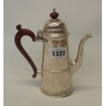 A 7" silver coffee pot of tapered design with red stained knop and scroll handle, retailed by