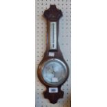 A small mid 20th Century carved oak cased banjo barometer/thermometer