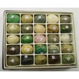 A boxed collection of twenty five miniature specimen stone eggs including yellow jasper, serpentine,