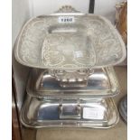 Two silver plated entree dishes and a decorative serving dish