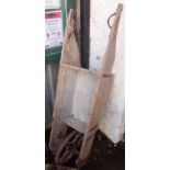 A 4' 11" old wood and iron wheelbarrow