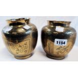 A pair of oriental brass baluster vases with all-over floral decoration and rubbed character marks