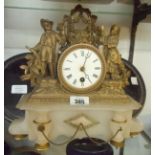 A 19th Century gilt spelter and alabaster cased figural mantel timepiece, set on an ebonised oval