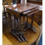 A nest of three reproduction mahogany, cross banded and strung tea tables, set on slender ring