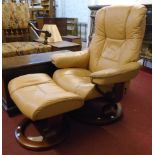 An Ekornes (Norway) "Stressless" easy chair and matching footstool upholstered in pale brown