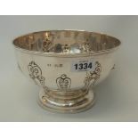 A 7¾" diameter silver pedestal rose bowl with embossed decoration - London 1907
