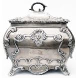 A 4" Georgian style silver bombe tea caddy with embossed and cast decoration and decorative hinged