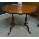 A 24" reproduction mahogany piecrust occasional table, set on Georgian style standard ends with