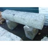 A 4' 2" rustic granite bench formed from two quoin stones and a sill