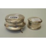 Two silver ring boxes, both with hinged lids and material lined interiors, the larger set on pad