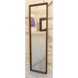 A stained oak framed narrow oblong wall mirror