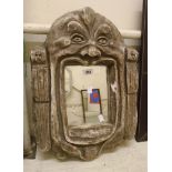 A decorative painted cast plaster mask pattern wall mirror