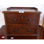 A 14" late Victorian mahogany two drawer trinket chest, set on squat turned feet - from a dressing