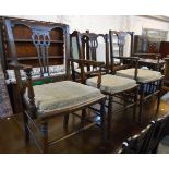 A set of six early 20th Century stained beech framed dining chairs with pierced splat backs and