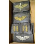 A cigar box containing a small collection of Cold War era USAF embroidered gilt badges on leather