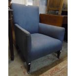 An Edwardian parlour armchair upholstered in blue material set on square tapered front legs and iron