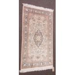 A Middle Eastern rug with central floral medallion and spandrels within a floral border, blue,