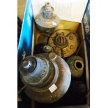 A box containing various old oil lamp bases, etc.