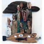 †Alan Faulds: a modern driftwood sculpture of men standing over a large fish, "Instead of going to