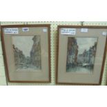 A pair of oak framed watercolours, one depicting a Dutch street scene, the other a canal scene in