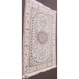 A Middle Eastern rug with central medallion and opposing floral sprays within a floral border,