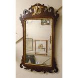 A 29¼" late Georgian mahogany and parcel gilt fretwork framed wall mirror with original plate