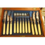 An oak cased set of twelve fish forks and eleven knives - sold with another canteen with part