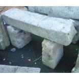 A 4' rustic granite bench formed from two quoin stones and a sill