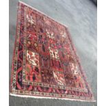 A large ground Persian panel main rug with stylised floral decoration within repeat borders,