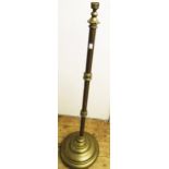A brass telescopic lamp standard with loaded circular base