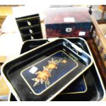 An Oriental lacquered jewellery box - sold with another and two lacquered trays