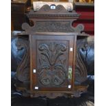 A 28" Edwardian carved walnut wall hanging cabinet with shaped pediment, acanthus scroll
