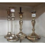 A pair of silver plated candlesticks of faceted design with detachable nozzles - sold with a pair of