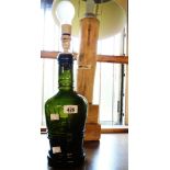 A dark green bottle lamp - sold with a driftwood lamp and shade