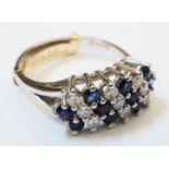 A marked 18kt. white metal ring, set with alternating diagonal rows of small diamonds and sapphires