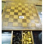 An early 20th Century mixed wood chess board with internal drawer containing a contemporary