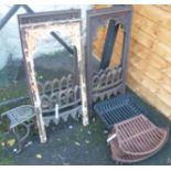 A set of four cast iron fire surrounds, three grates and an iron and brass trivet