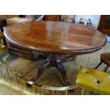 A 4' 3" Victorian walnut quarter veneered, inlaid and carved loo table, set on turned pillar and