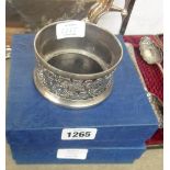 Two boxed silver plated wine coasters, both with pierced rims and polished oak bases - sold with