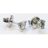 A pair of marked 750 white metal diamond solitaire stud ear-rings - approx. 1ct. TDW