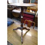 A 20" diameter Victorian stained mixed wood pedestal table, set on turned pillar and tripod base -