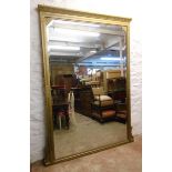 A 19th Century gilt framed wall mirror with decorative moulding, canted bevelled plate and