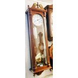 A 3' 5" reproduction stained wood cased Vienna regulator style wall clock with visible pendulum