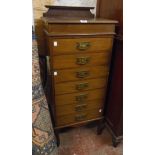 An 18" Edwardian mahogany chest with moulded raised back and seven drawers with embossed backplate