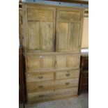 A 5' 1" 19th Century three part stripped pine housemaid's cupboard with two pairs of panelled