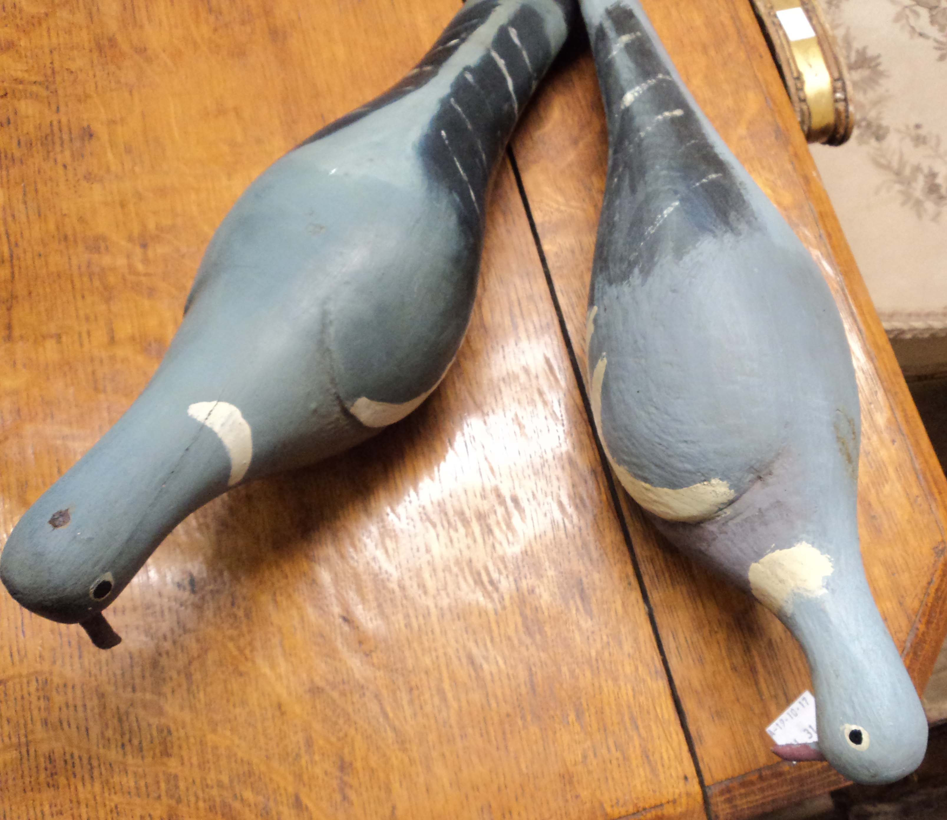 Two hand painted wood pigeon decoys