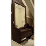 A 29" late Victorian stained walnut bevelled oblong wall mirror with lift-top compartment and