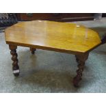 A polished oak tea table, set on barley twist supports