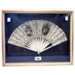 A framed mid 19th Century French fan with painted panel decoration and bone sticks