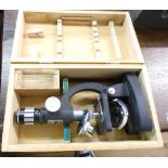 A modern cased Bijou student's microscope